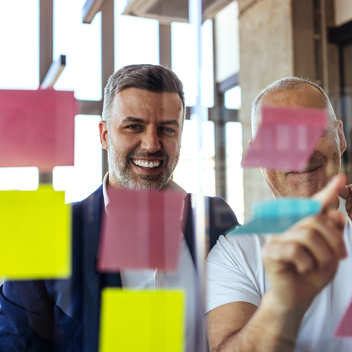 people moving post-it notes around
