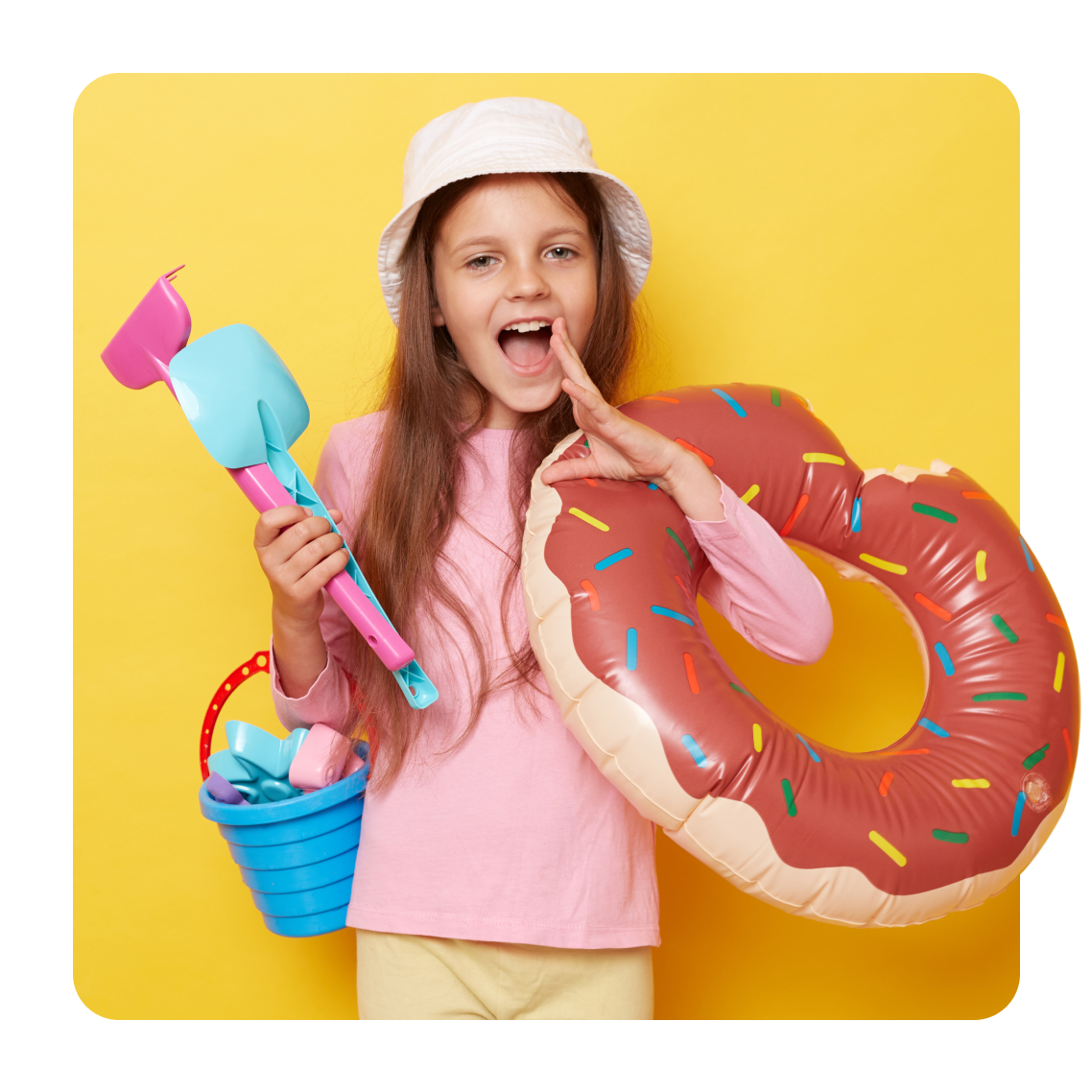 a girl with a bucket, spade and rubber ring